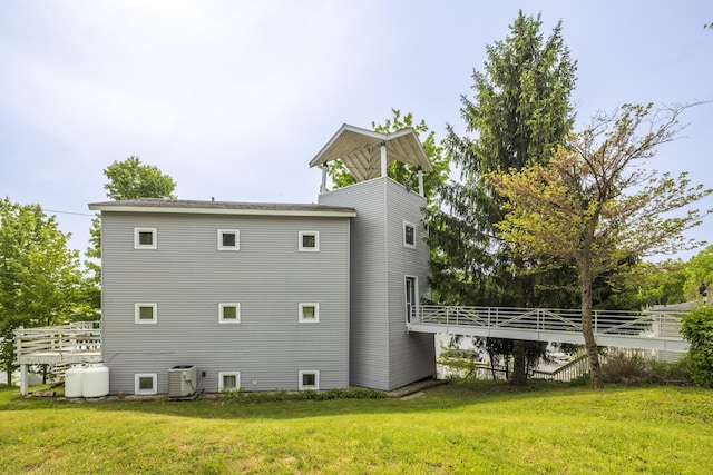 15657 Lakeview Dr, Buchanan, MI 49107 - back of property with cooling unit, a lawn, and a deck