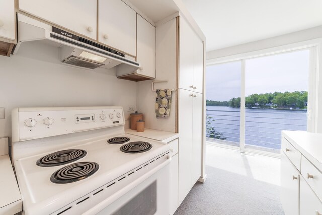 15657 Lakeview Dr, Buchanan, MI 49107 - kitchen with white range with electric stovetop, white cabinetry, light countertops, and a water view