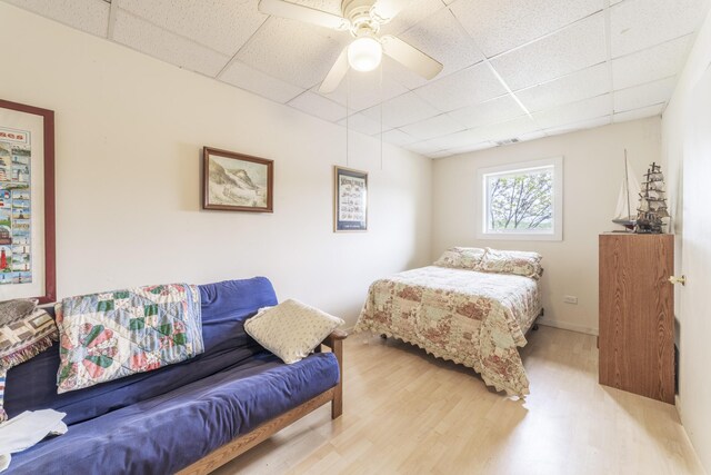 15657 Lakeview Dr, Buchanan, MI 49107 - bedroom with a paneled ceiling, light wood-style flooring, and a ceiling fan
