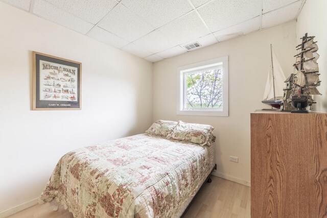 15657 Lakeview Dr, Buchanan, MI 49107 - bedroom featuring a drop ceiling, light wood finished floors, and baseboards