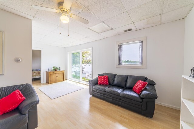 15657 Lakeview Dr, Buchanan, MI 49107 - living area with wood finished floors, a paneled ceiling, a ceiling fan, and baseboards