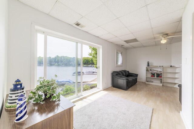 15657 Lakeview Dr, Buchanan, MI 49107 - living area with a paneled ceiling, light wood-style flooring, a water view, and a ceiling fan