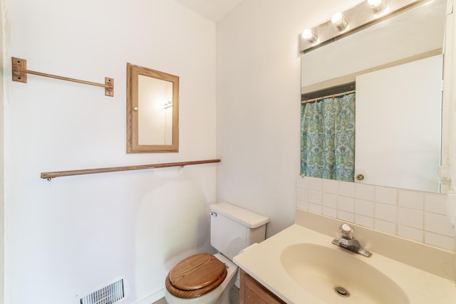 15657 Lakeview Dr, Buchanan, MI 49107 - bathroom with toilet, vanity, and tasteful backsplash