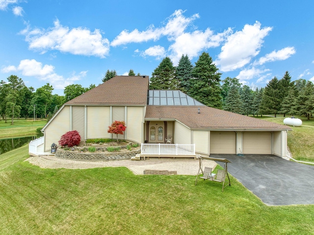 12741 Sharon Hollow Rd, Manchester, MI 48158 - view of front of house featuring a front yard, a porch, roof with shingles, and an attached garage