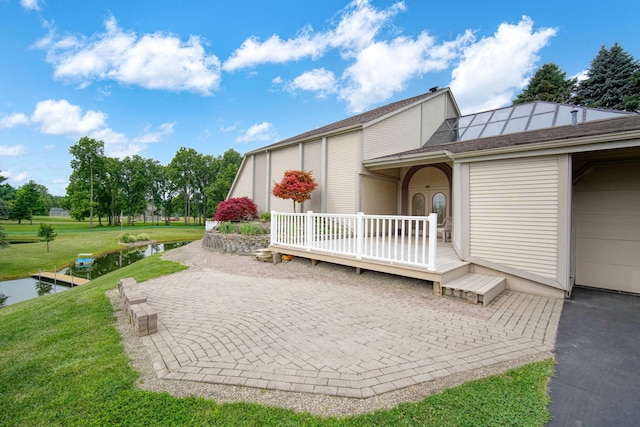 12741 Sharon Hollow Rd, Manchester, MI 48158 - view of home's exterior featuring a yard, a deck with water view, and a patio area