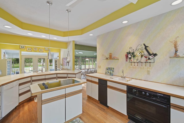 12741 Sharon Hollow Rd, Manchester, MI 48158 - kitchen with white dishwasher, oven, wallpapered walls, a sink, and light wood-style floors