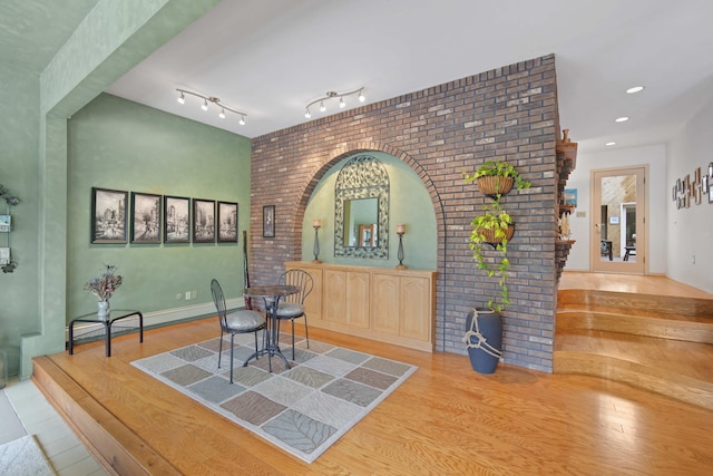 12741 Sharon Hollow Rd, Manchester, MI 48158 - dining area with wood finished floors, brick wall, and recessed lighting