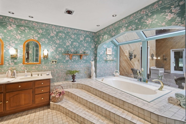 12741 Sharon Hollow Rd, Manchester, MI 48158 - bathroom featuring a garden tub, vanity, wallpapered walls, and tile patterned flooring