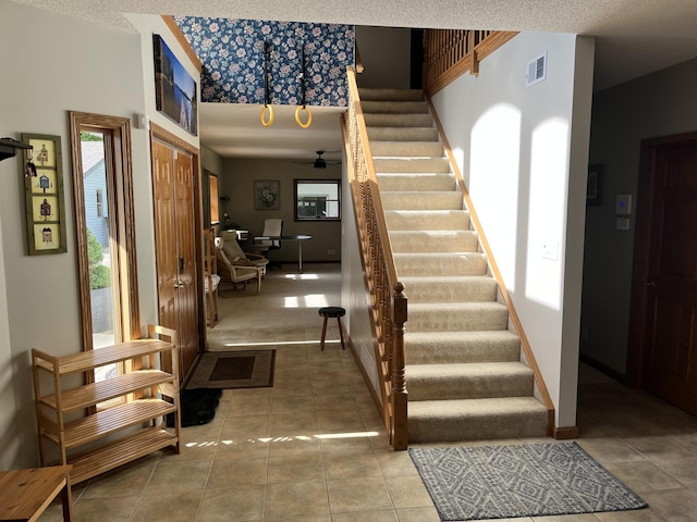 7033 N M-140, Watervliet, MI 49098 - tiled foyer entrance featuring stairway, a ceiling fan, and baseboards