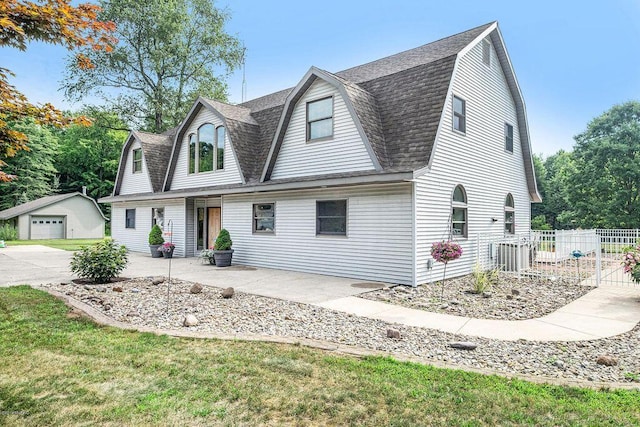 7033 N M-140, Watervliet, MI 49098 - colonial inspired home with a gambrel roof, a shingled roof, and an outbuilding