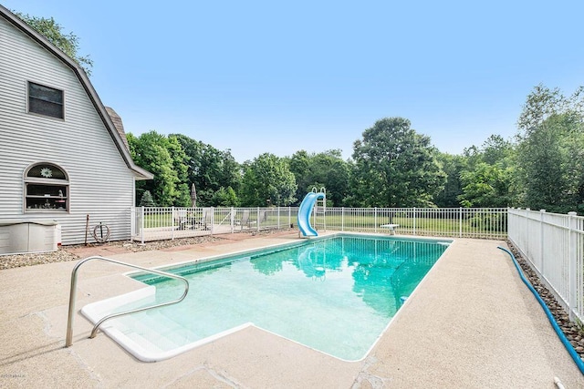7033 N M-140, Watervliet, MI 49098 - view of pool featuring a water slide and a patio area