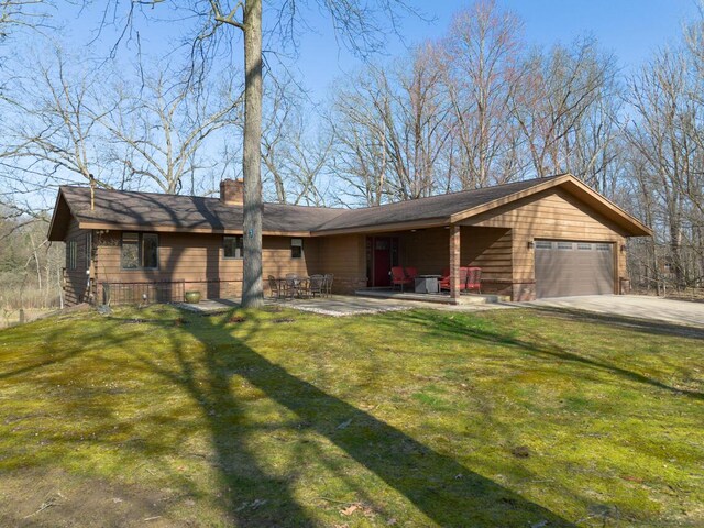 10989 E D E Ave, Richland, MI 49083 - view of front of property featuring a chimney, a front yard, and an attached garage