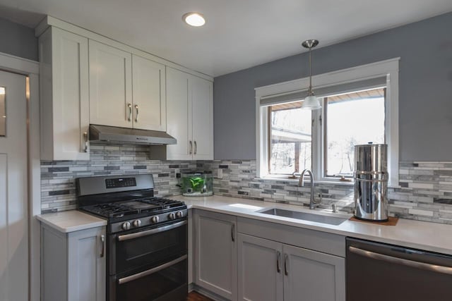10989 E D E Ave, Richland, MI 49083 - kitchen with under cabinet range hood, stainless steel appliances, a sink, light countertops, and recessed lighting