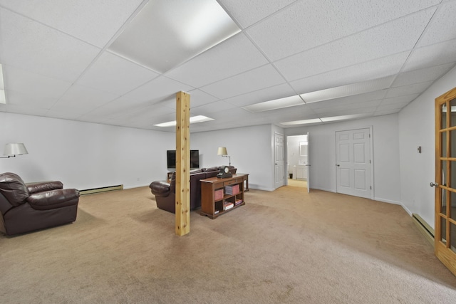 12021 Pope Church Rd, Springport, MI 49284 - carpeted living area with a baseboard heating unit, a paneled ceiling, and baseboards