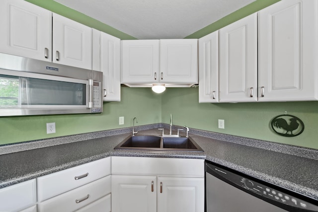 12021 Pope Church Rd, Springport, MI 49284 - kitchen with stainless steel appliances, a sink, white cabinetry, and dark countertops