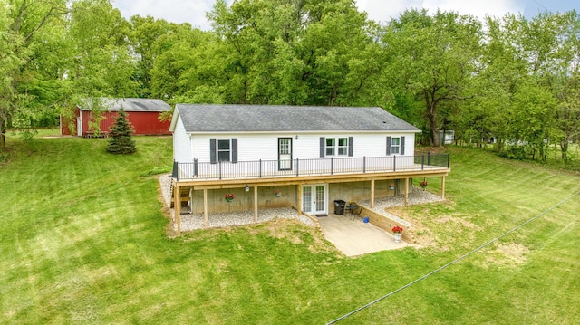 12021 Pope Church Rd, Springport, MI 49284 - rear view of property featuring french doors, a wooden deck, a lawn, and a patio area