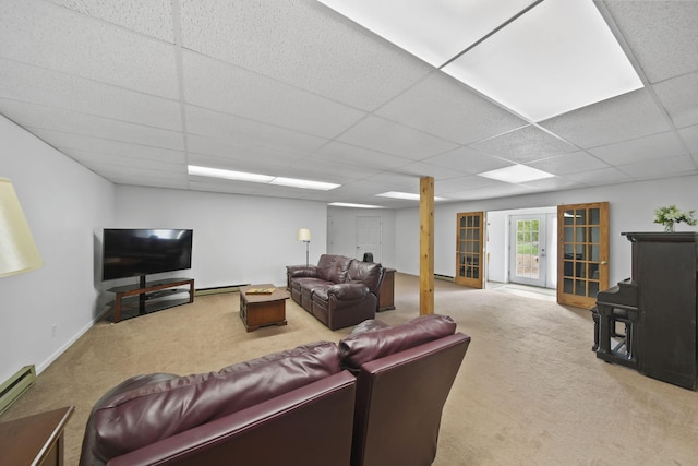 12021 Pope Church Rd, Springport, MI 49284 - carpeted living room with a paneled ceiling and a baseboard heating unit