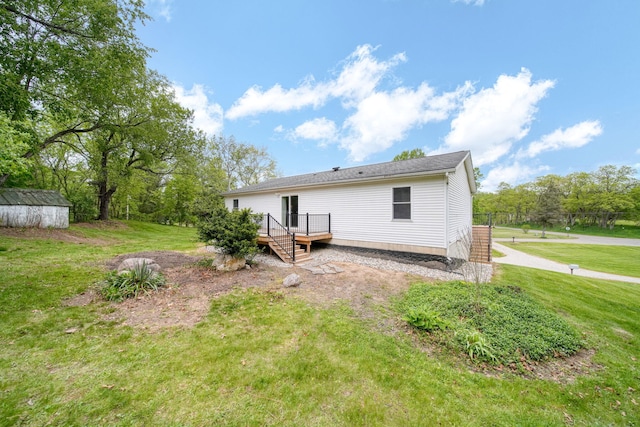 12021 Pope Church Rd, Springport, MI 49284 - back of property featuring a lawn and a wooden deck