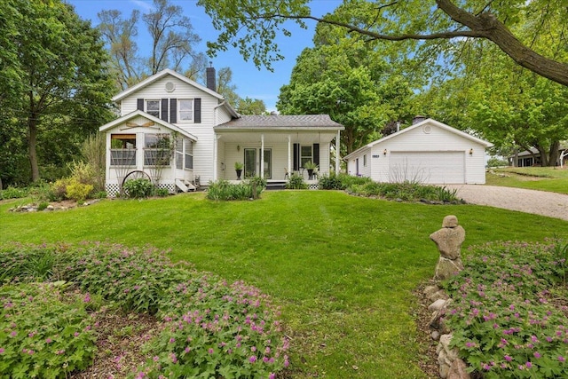 236 Simpson St, Grass Lake, MI 49240 - view of front of property featuring a chimney, a porch, a front yard, a detached garage, and an outbuilding