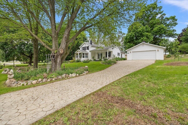 236 Simpson St, Grass Lake, MI 49240 - view of front of house with a front yard, a detached garage, and a porch