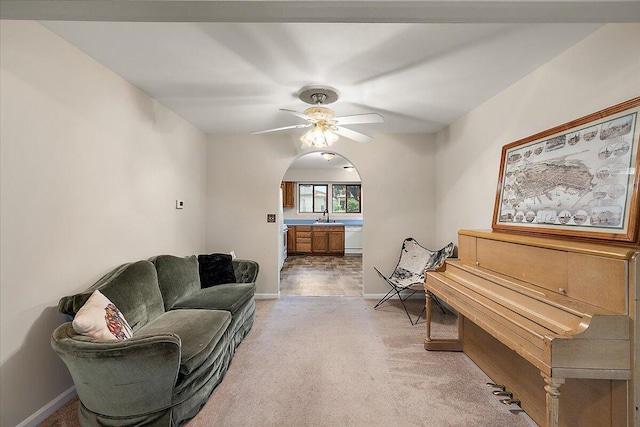 236 Simpson St, Grass Lake, MI 49240 - sitting room with arched walkways, a ceiling fan, light carpet, and baseboards
