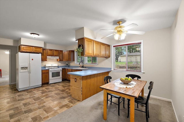 236 Simpson St, Grass Lake, MI 49240 - kitchen featuring white appliances, a sink, a peninsula, and brown cabinets
