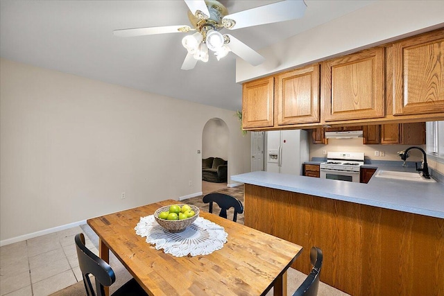 236 Simpson St, Grass Lake, MI 49240 - dining room with arched walkways, ceiling fan, light tile patterned flooring, and baseboards
