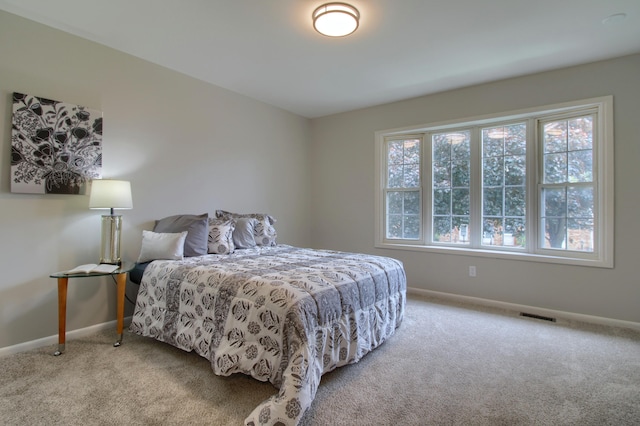 2611 Kingstowne Dr, Michigan, MI 48390 - carpeted bedroom featuring multiple windows and baseboards