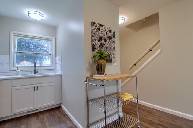 2611 Kingstowne Dr, Michigan, MI 48390 - corridor with a sink, dark wood finished floors, and baseboards