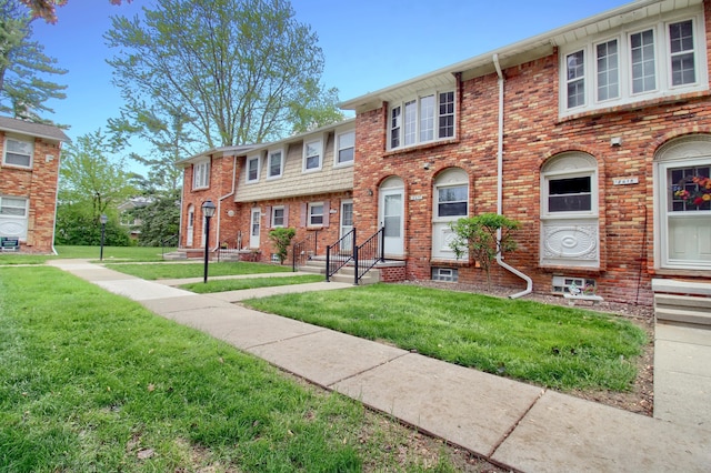 2611 Kingstowne Dr, Michigan, MI 48390 - townhome / multi-family property featuring a front lawn and brick siding