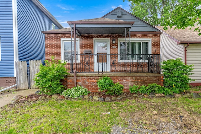 1509 Ferris Ave, Lincoln Park, MI 48146 - view of front of property featuring brick siding, a shingled roof, and covered porch