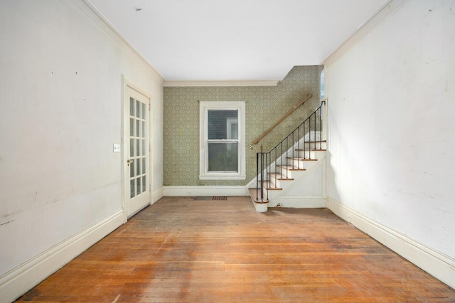554 Ethel Ave SE, Grand Rapids, MI 49506 - foyer entrance featuring stairs, wood finished floors, ornamental molding, baseboards, and wallpapered walls