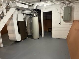 872 Mcalister Ave, Benton Harbor, MI 49022 - unfinished basement featuring electric panel and gas water heater