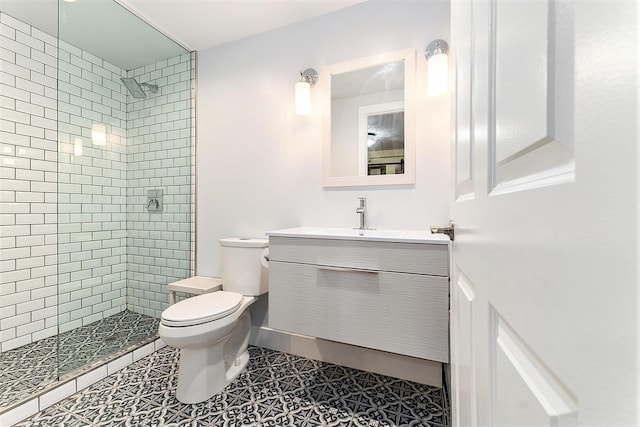 810 Cottageview Dr, Traverse City, MI 49684 - full bathroom featuring toilet, tiled shower, vanity, and tile patterned flooring