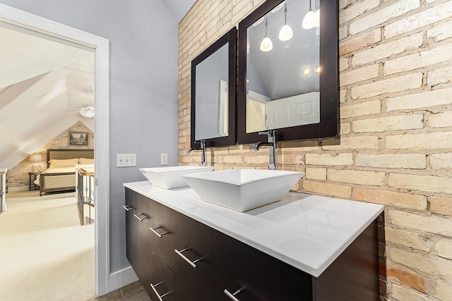 810 Cottageview Dr, Traverse City, MI 49684 - bathroom with lofted ceiling, double vanity, and ceiling fan
