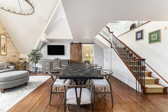 810 Cottageview Dr, Traverse City, MI 49684 - dining space with stairs, a barn door, hardwood / wood-style flooring, and baseboards