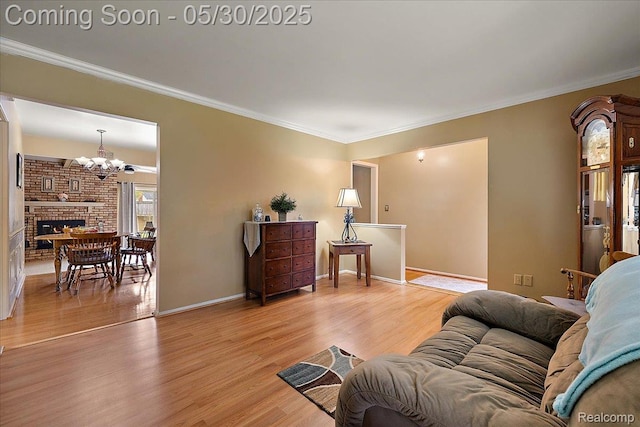 7188 Vicksburg Cir, Shelby Twp, MI 48317 - living area featuring a chandelier, light wood-type flooring, ornamental molding, baseboards, and a fireplace