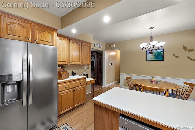 7188 Vicksburg Cir, Shelby Twp, MI 48317 - kitchen with stainless steel fridge with ice dispenser, light wood-style floors, a chandelier, pendant lighting, and light countertops