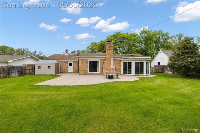 7188 Vicksburg Cir, Shelby Twp, MI 48317 - rear view of house featuring a chimney, a patio area, and brick siding
