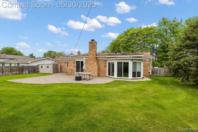 7188 Vicksburg Cir, Shelby Twp, MI 48317 - back of house featuring a patio, a chimney, brick siding, and a gate
