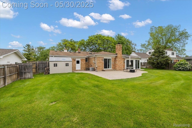 7188 Vicksburg Cir, Shelby Twp, MI 48317 - rear view of house with a chimney, a patio area, brick siding, and central AC