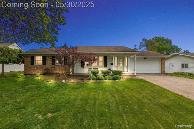 7188 Vicksburg Cir, Shelby Twp, MI 48317 - ranch-style house with covered porch, an attached garage, concrete driveway, and brick siding