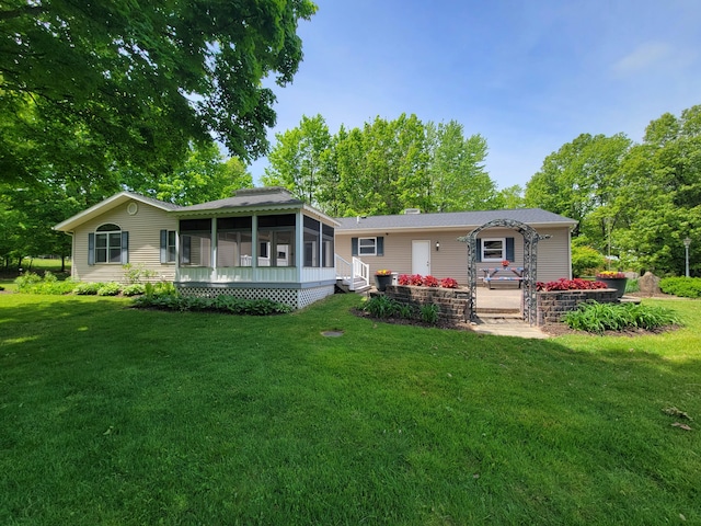 9490 N 12th St, Kalamazoo, MI 49009 - rear view of property featuring a sunroom, a lawn, and a chimney