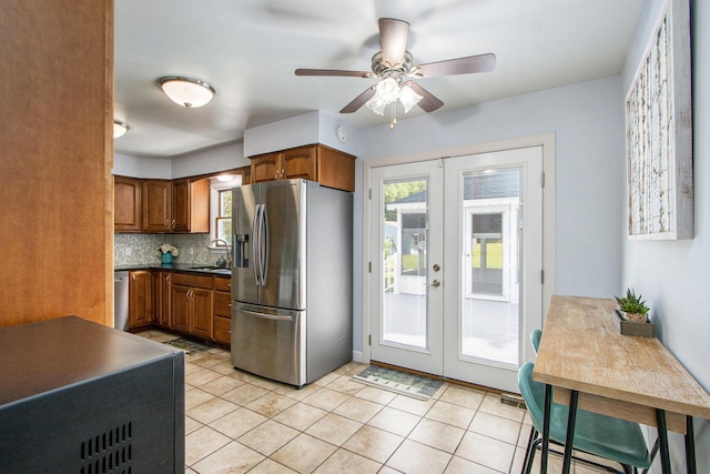 9490 N 12th St, Kalamazoo, MI 49009 - kitchen featuring stainless steel appliances, french doors, brown cabinetry, and a sink