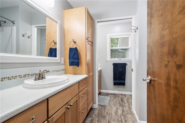 9490 N 12th St, Kalamazoo, MI 49009 - full bath featuring vanity, wood finished floors, backsplash, baseboards, and a shower