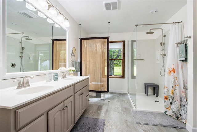 9490 N 12th St, Kalamazoo, MI 49009 - bathroom featuring a shower stall, double vanity, wood finished floors, and baseboards