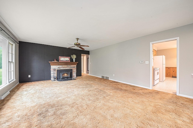 7432 Burlingame Ave SW, Byron Center, MI 49315 - unfurnished living room featuring carpet floors, a ceiling fan, and baseboards