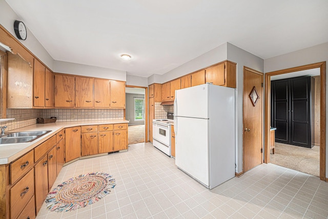 7432 Burlingame Ave SW, Byron Center, MI 49315 - kitchen with white appliances, a sink, light countertops, backsplash, and under cabinet range hood