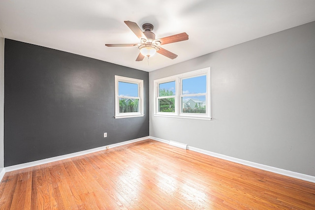 7432 Burlingame Ave SW, Byron Center, MI 49315 - unfurnished room with light wood-style flooring, baseboards, and ceiling fan