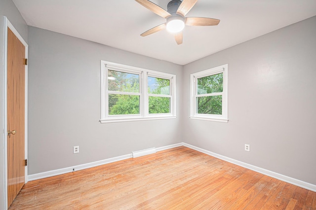 7432 Burlingame Ave SW, Byron Center, MI 49315 - empty room with baseboards, light wood-style flooring, and a ceiling fan